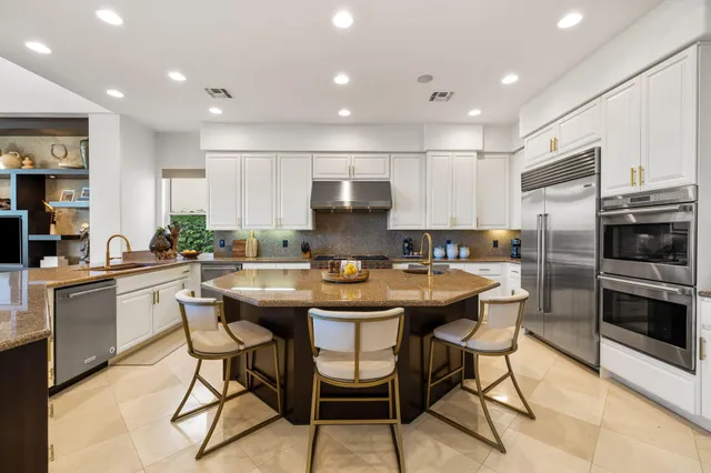 a view of a backyard with swimming pool and sitting area