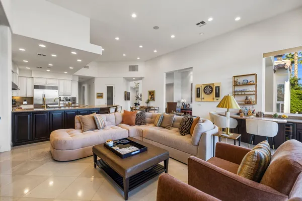 a spacious bedroom with a large bed a flat tv screen and a fireplace