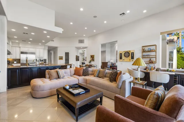 a spacious bedroom with a large bed a flat tv screen and a fireplace