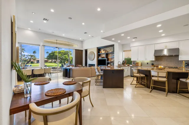a living room with furniture and painting on the wall