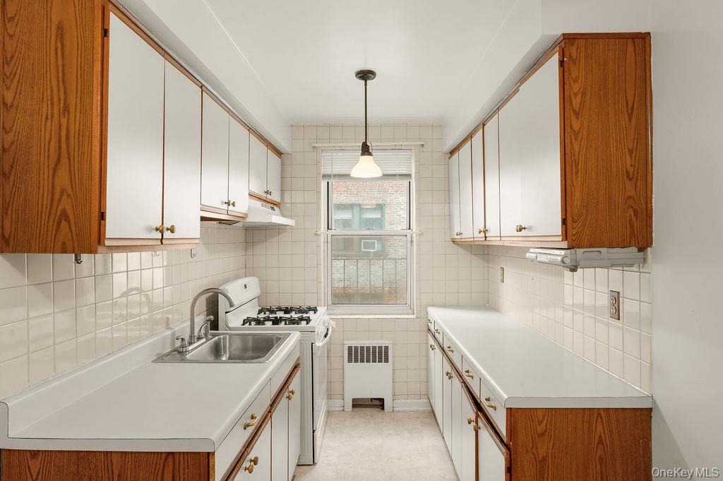 485 Bronx River Road, Unit A21 Yonkers, NY 10704 - Photo 2 of 18 a kitchen with stainless steel appliances a sink stove and cabinets