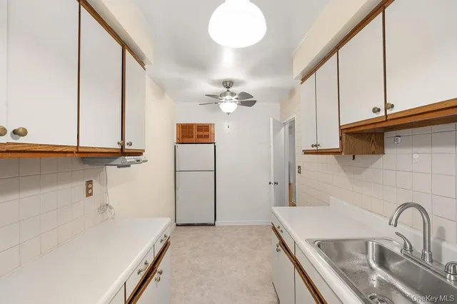 a kitchen with a sink and a refrigerator