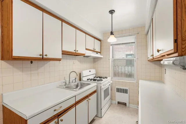 a kitchen with stainless steel appliances a sink a stove and a window