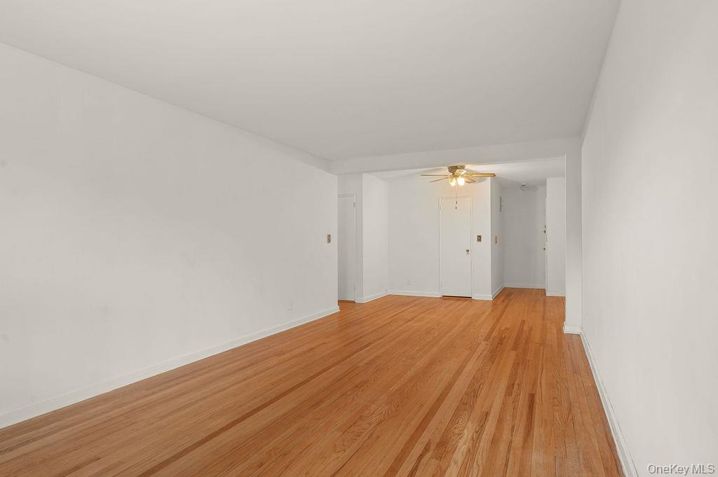 485 Bronx River Road, Unit A21 Yonkers, NY 10704 - Photo 6 of 18 a view of empty room with wooden floor