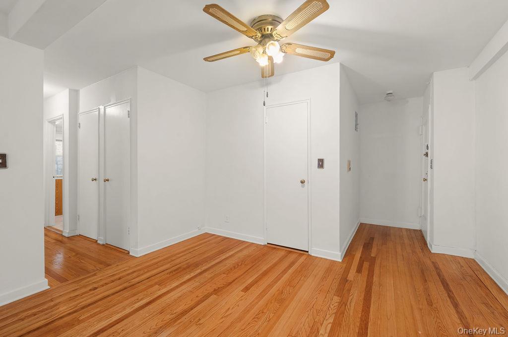 485 Bronx River Road, Unit A21 Yonkers, NY 10704 - Photo 7 of 18 a view of a room with wooden floor and a ceiling fan