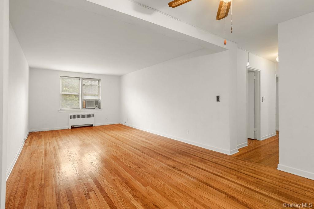 485 Bronx River Road, Unit A21 Yonkers, NY 10704 - Photo 8 of 18 an empty room with wooden floor and windows