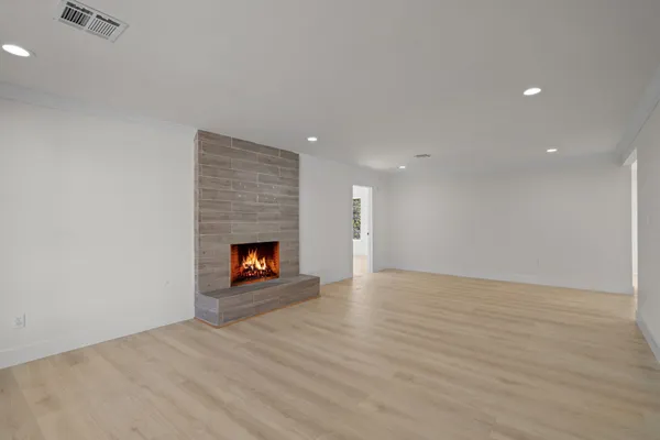 a view of an empty room and fire place
