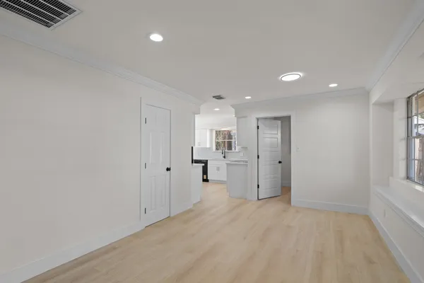 a view of a kitchen with a refrigerator and windows