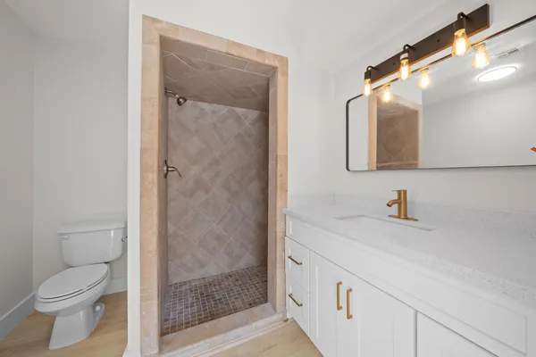 a living room with a baby crib and a wooden floor