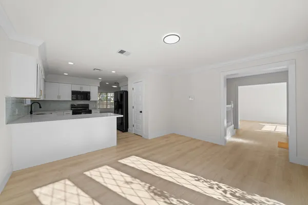 a view of kitchen with kitchen island sink and refrigerator