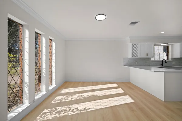 a bathroom with a granite countertop sink and a window
