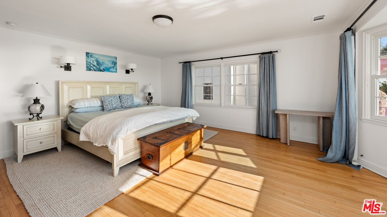 605 Palisades Beach Road Santa Monica, CA 90402 - Photo 25 of 33 a bedroom with a bed wooden floor and window