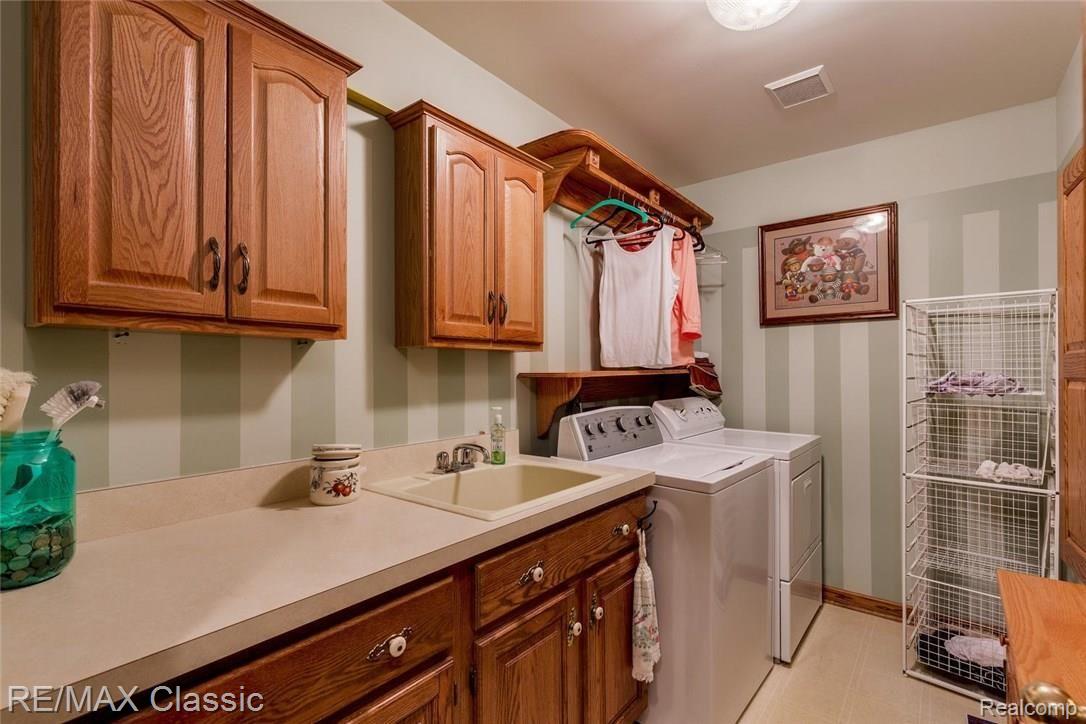 3056 Rivers Edge Drive North Wayne, MI 48184 - Photo 25 of 27 First Floor Laundry Room with great built in cabinets also in maple.