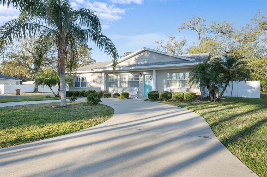 230 Palm Drive Flagler Beach, FL 32136 - Photo 1 of 1 a front view of house with yard and green space