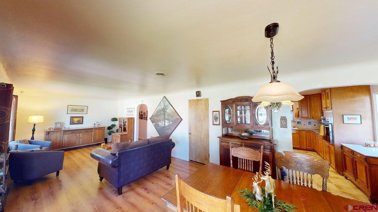 96 El Rio Drive Alamosa, CO 81101 - Photo 2 of 18 a living room with furniture and a chandelier