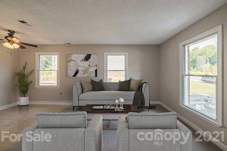 922 Capps Hill Mine Road Charlotte, NC 28216 - Photo 2 of 10 a living room with furniture and a large window