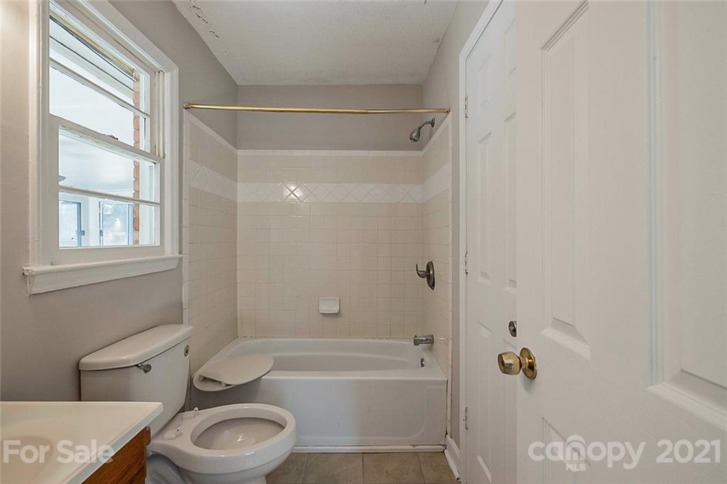 922 Capps Hill Mine Road Charlotte, NC 28216 - Photo 9 of 10 a bathroom with a sink a toilet and shower