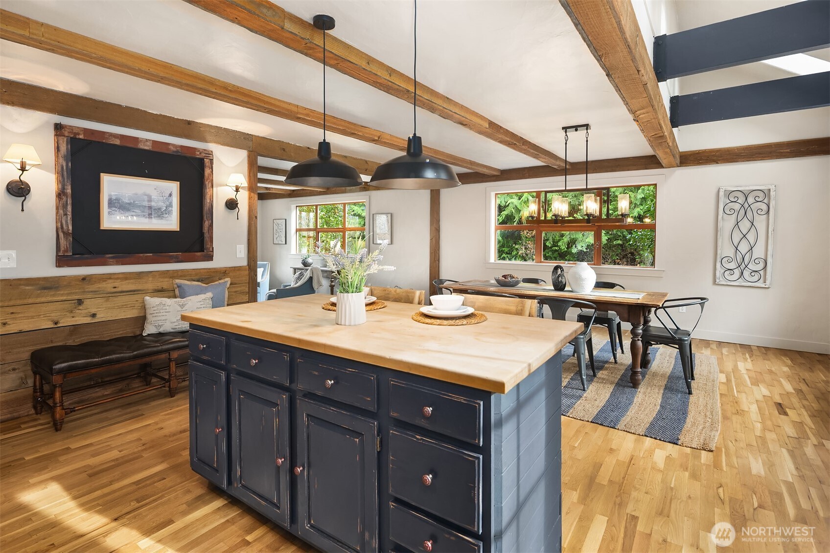 41715 Southeast 101st Street North Bend, WA 98045 - Photo 11 of 38 a dining hall with stainless steel appliances granite countertop a sink a stove a dining table and chairs with wooden floor