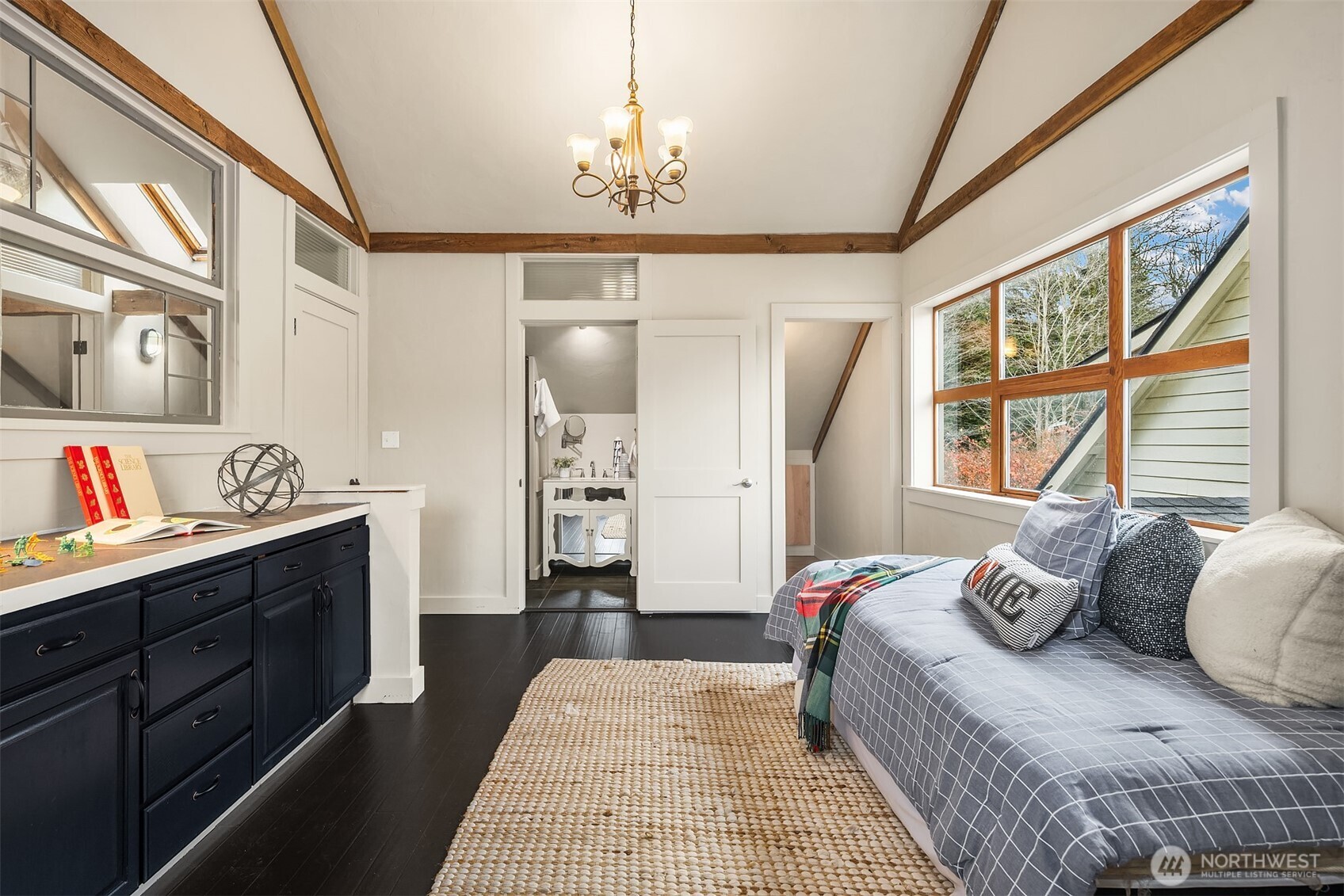 41715 Southeast 101st Street North Bend, WA 98045 - Photo 21 of 38 a bedroom with a bed and a chandelier