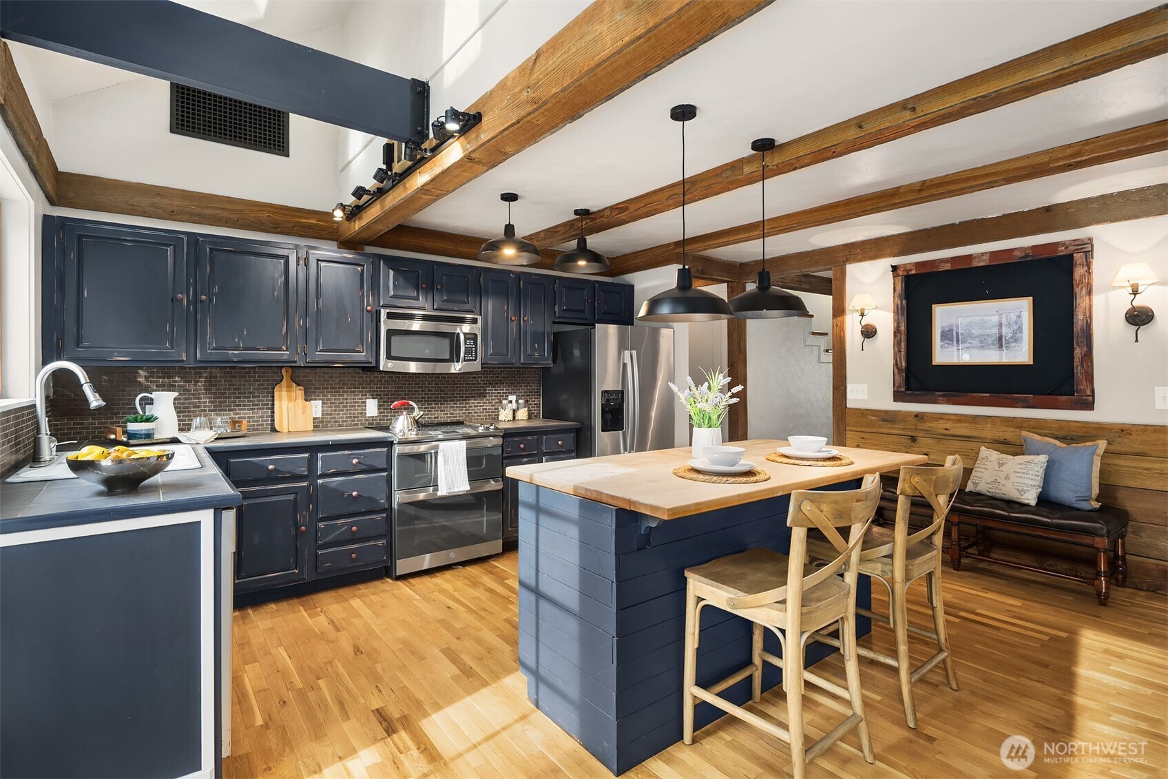 41715 Southeast 101st Street North Bend, WA 98045 - Photo 10 of 38 a kitchen with stainless steel appliances granite countertop a stove top oven a sink dishwasher and white cabinets with wooden floor