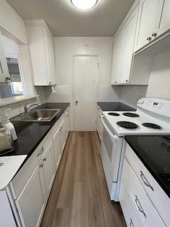 a kitchen with granite countertop a sink and cabinets