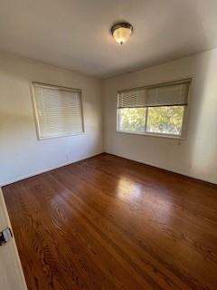 1956 Ivy Street, Unit 3 San Mateo, CA 94403 - Photo 4 of 8 an empty room with wooden floor and windows