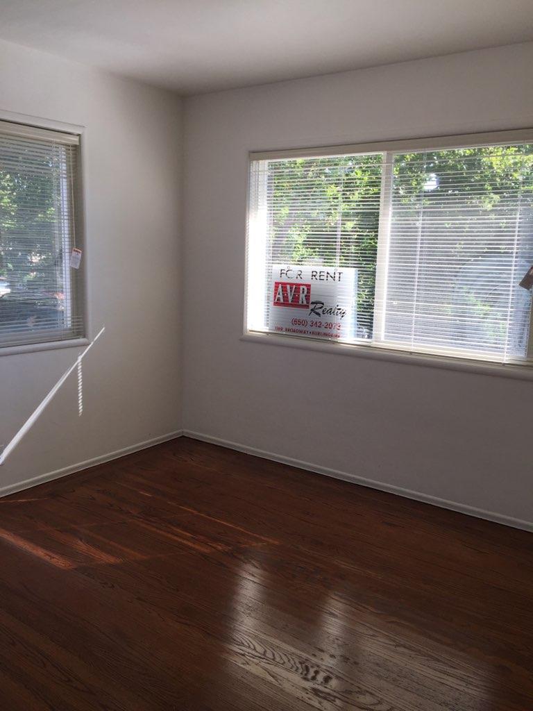 1956 Ivy Street, Unit 3 San Mateo, CA 94403 - Photo 5 of 8 a view of an empty room with wooden floor and a window
