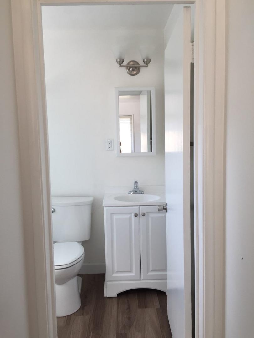 1956 Ivy Street, Unit 3 San Mateo, CA 94403 - Photo 8 of 8 a bathroom with a toilet a sink a vanity and mirror