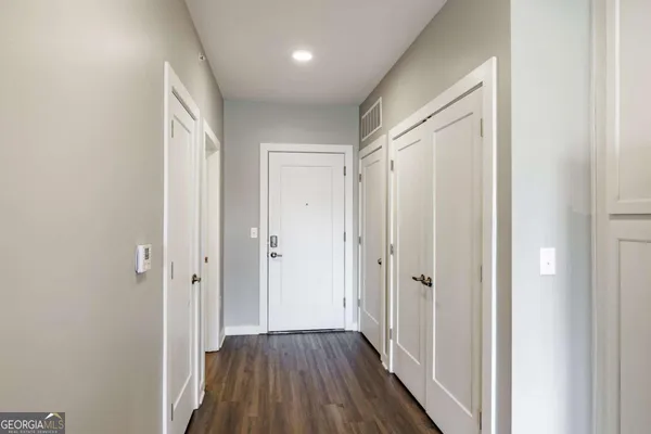 a view of a hallway with wooden floor