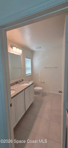 a view of a big room with wooden floor and windows