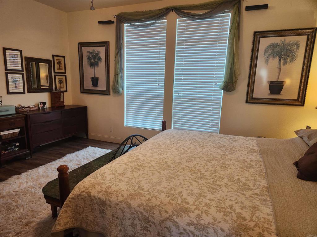 3909 Reche Road, Unit 30 Fallbrook, CA 92028 - Photo 11 of 52 a bedroom with a bed and paintings on the wall