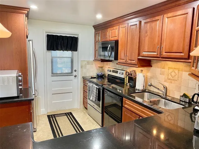a kitchen with a refrigerator stove and a sink