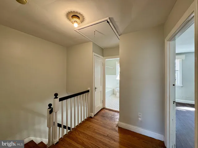 a view of a hallway with wooden floor
