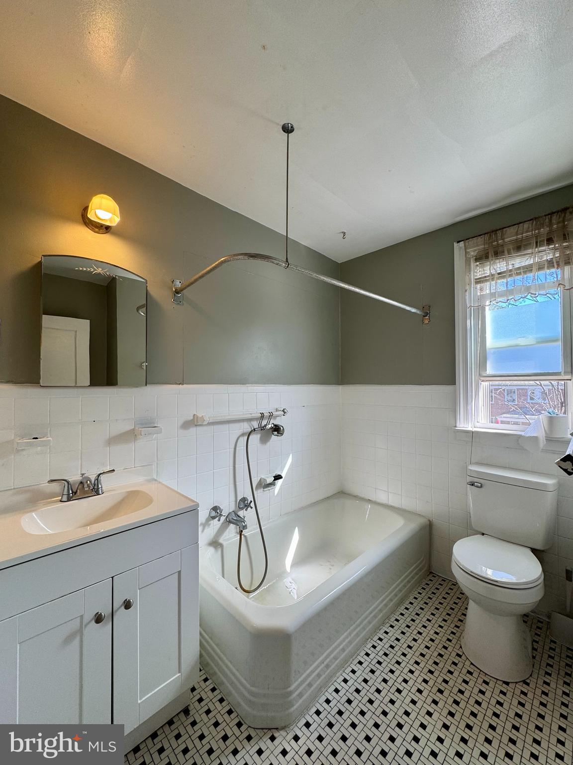 3704 Delverne Road Baltimore, MD 21218 - Photo 14 of 20 a bathroom with a sink toilet and a mirror