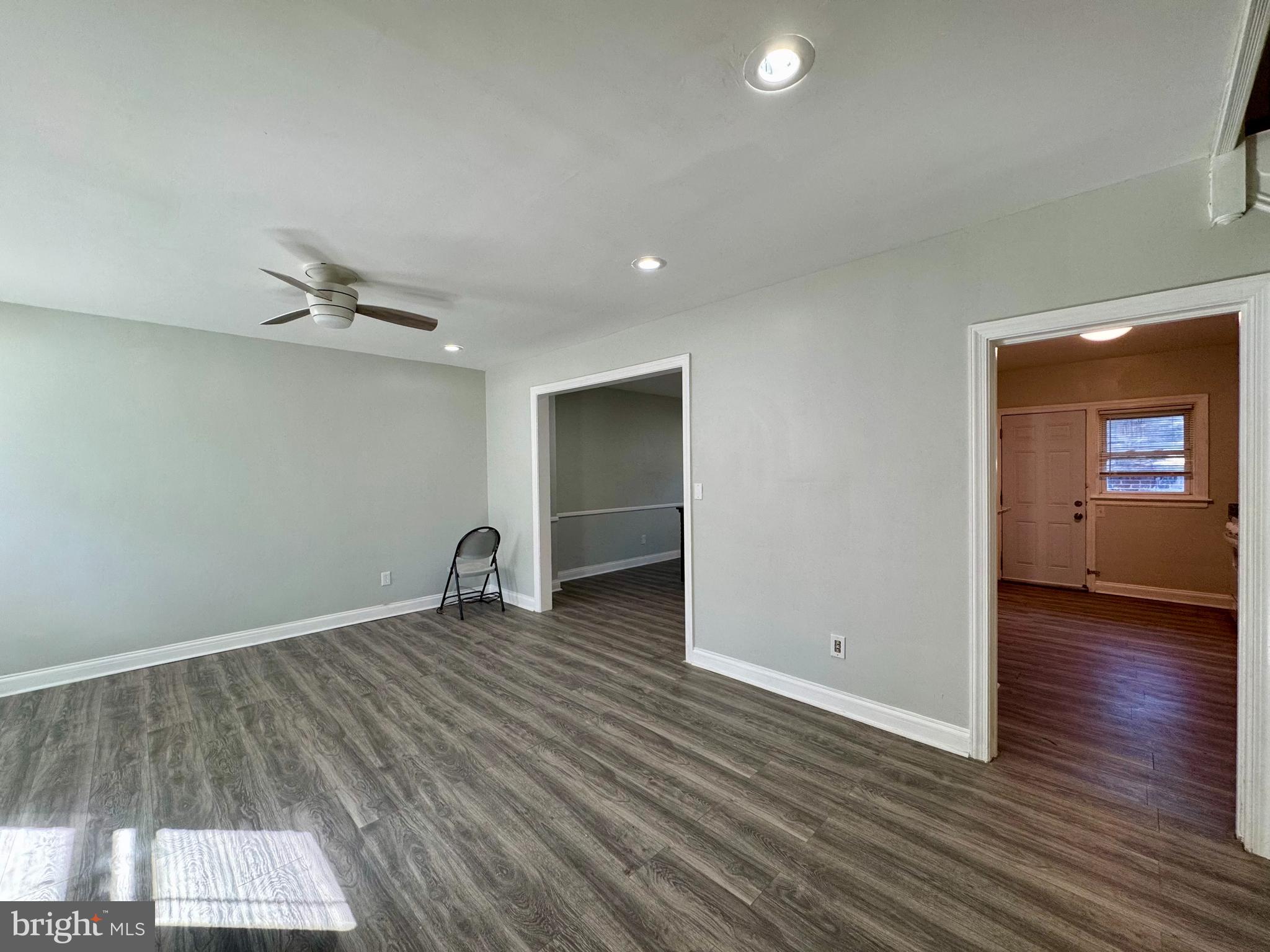 3704 Delverne Road Baltimore, MD 21218 - Photo 2 of 20 a view of a room with wooden floor and a ceiling fan