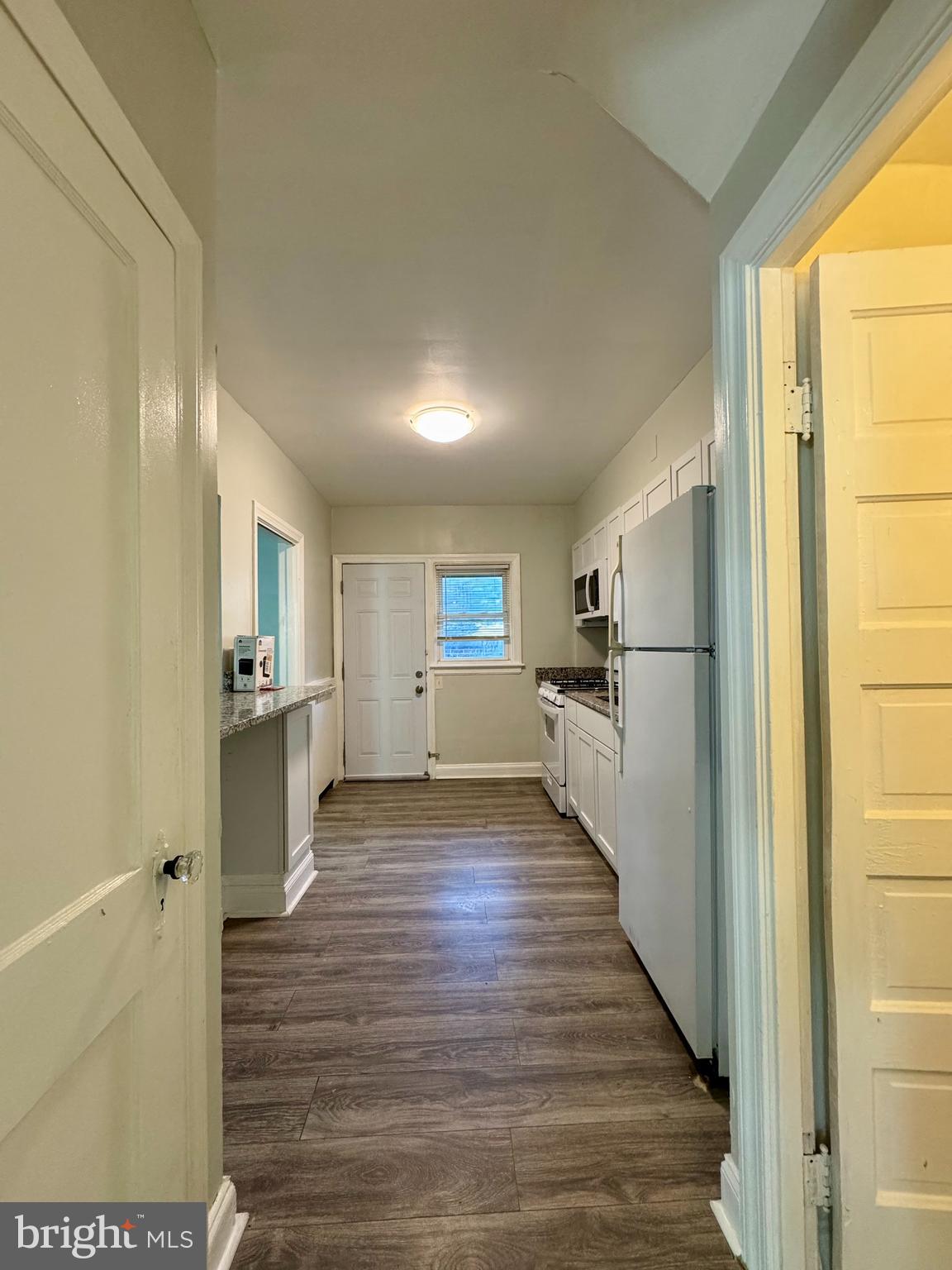 3704 Delverne Road Baltimore, MD 21218 - Photo 5 of 20 a view of a refrigerator in kitchen and wooden floor