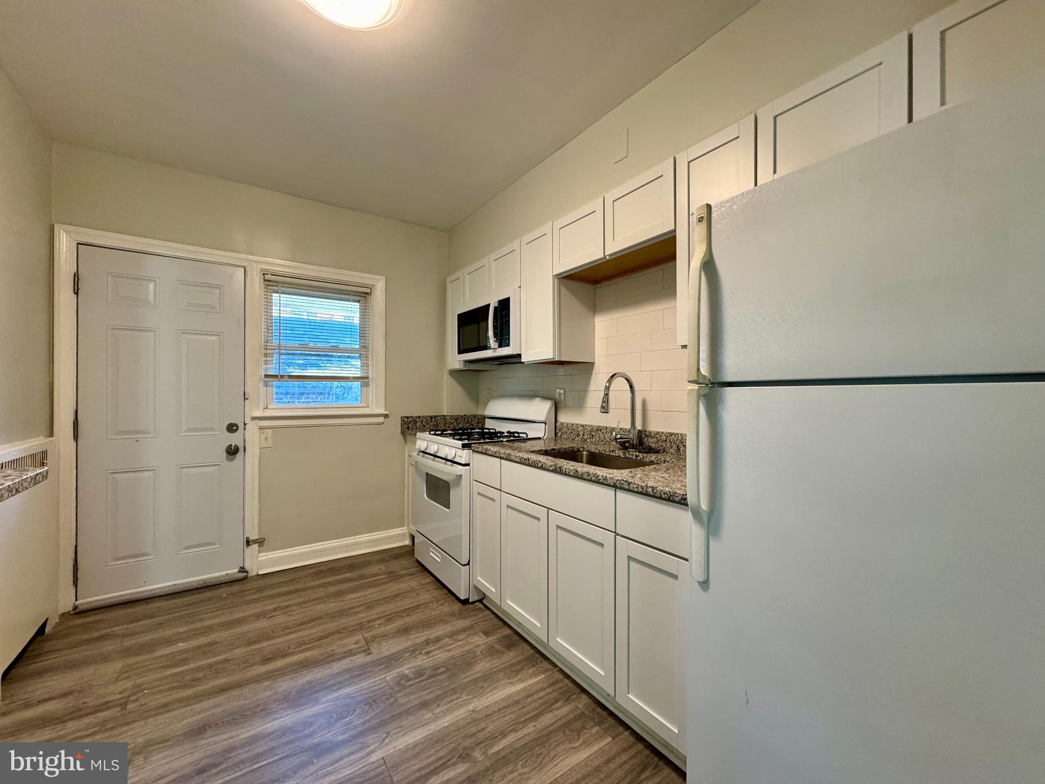 3704 Delverne Road Baltimore, MD 21218 - Photo 6 of 20 a kitchen with stainless steel appliances granite countertop a refrigerator and a stove top oven