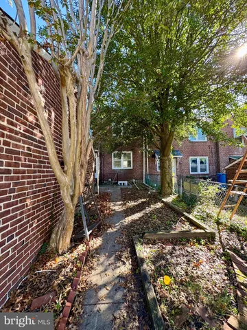 a tree in front of a white house