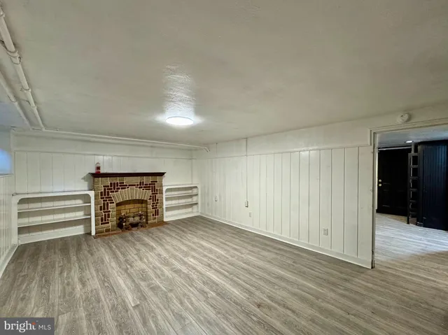 wooden floor in an empty room with a fireplace