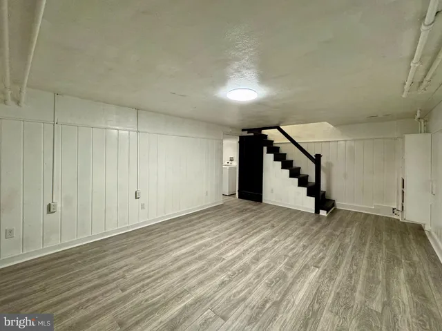 a view of an empty room with stairs and ventilation