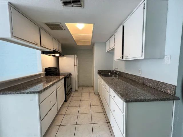 a kitchen with stainless steel appliances granite countertop a sink and a stove