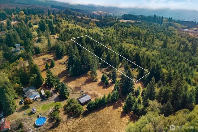 an aerial view of a house with a yard