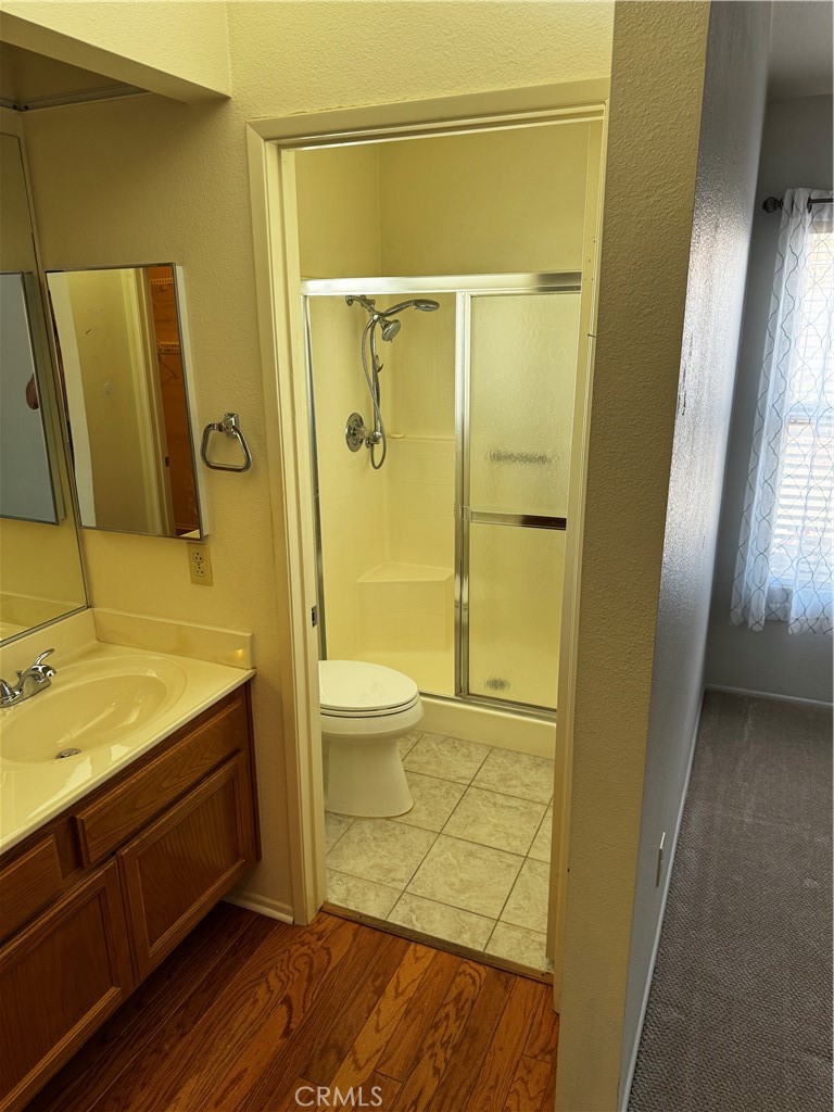 27519 Terrytown Road Menifee, CA 92586 - Photo 13 of 22 a bathroom with a granite countertop sink toilet and shower