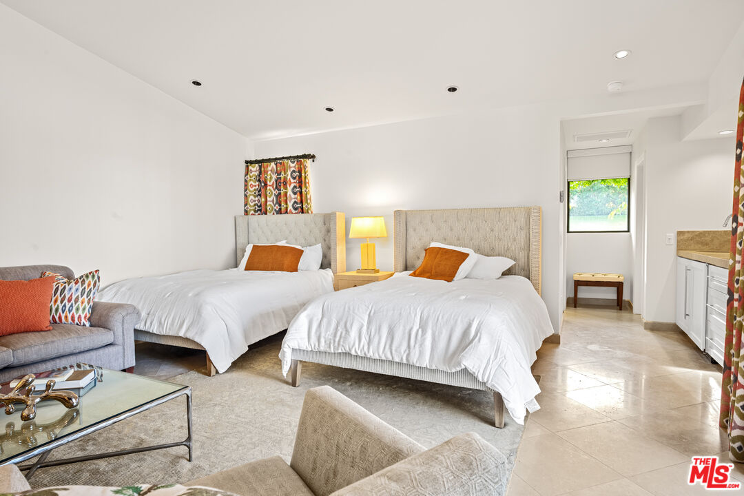 70461 Boothill Road Rancho Mirage, CA 92270 - Photo 61 of 68 a bedroom with two beds and painting on the wall