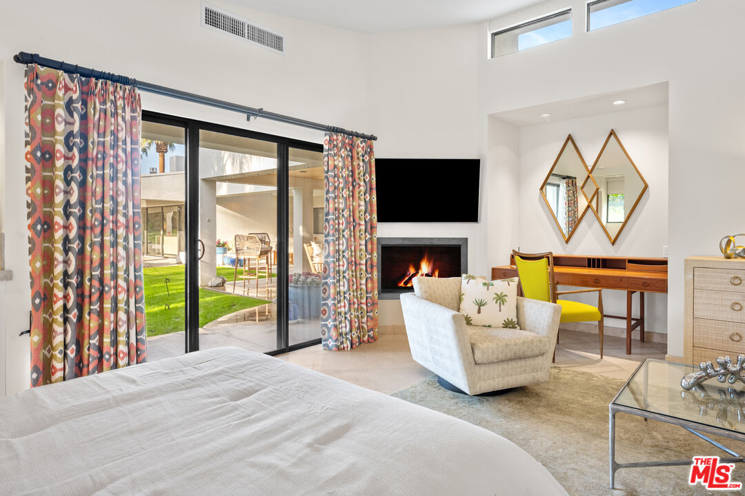 70461 Boothill Road Rancho Mirage, CA 92270 - Photo 63 of 68 a living room with furniture a fireplace and a flat screen tv