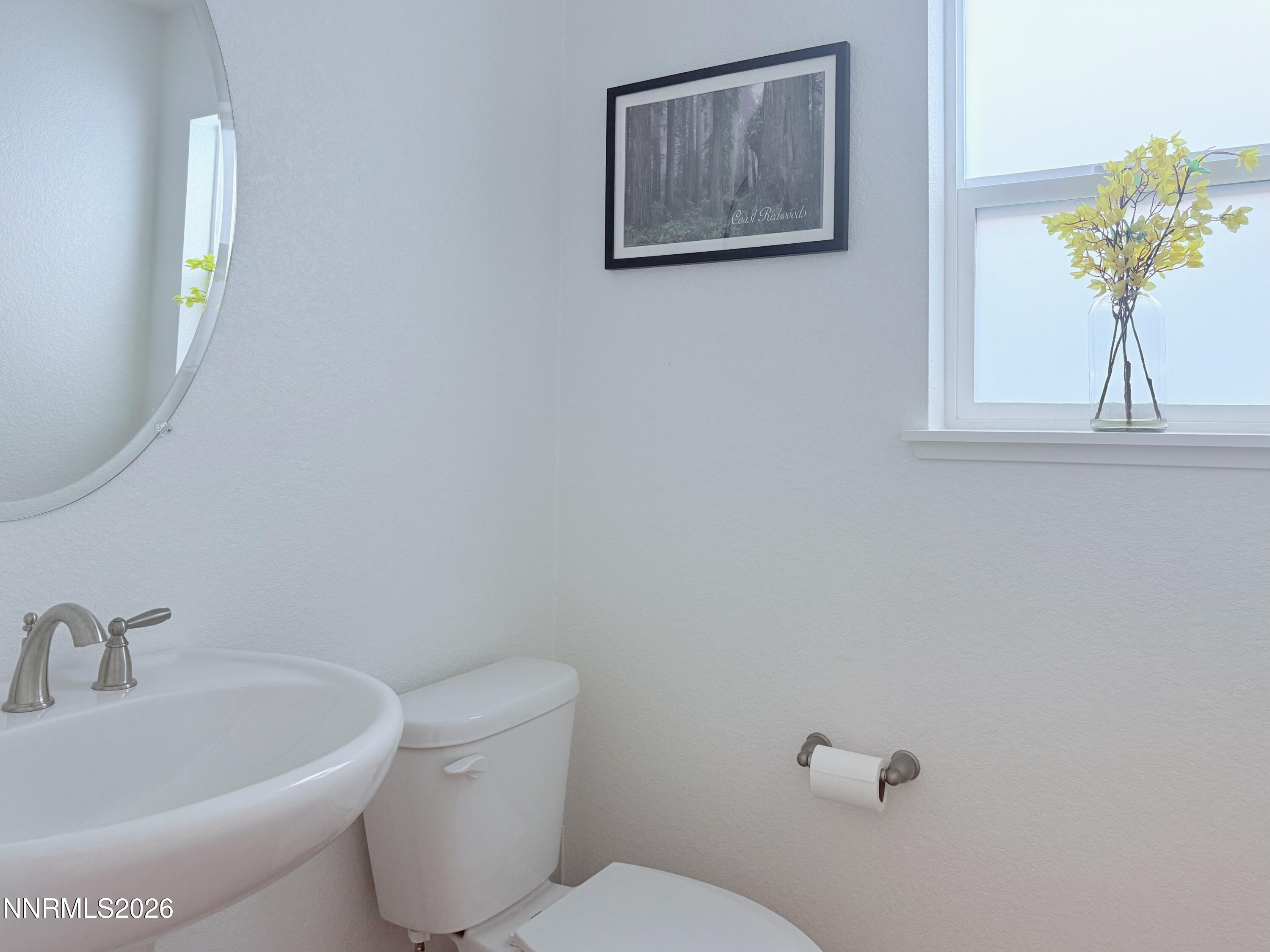 1433 Solitude Trail Reno, NV 89523 - Photo 14 of 35 a white toilet sitting next to a bathroom sink