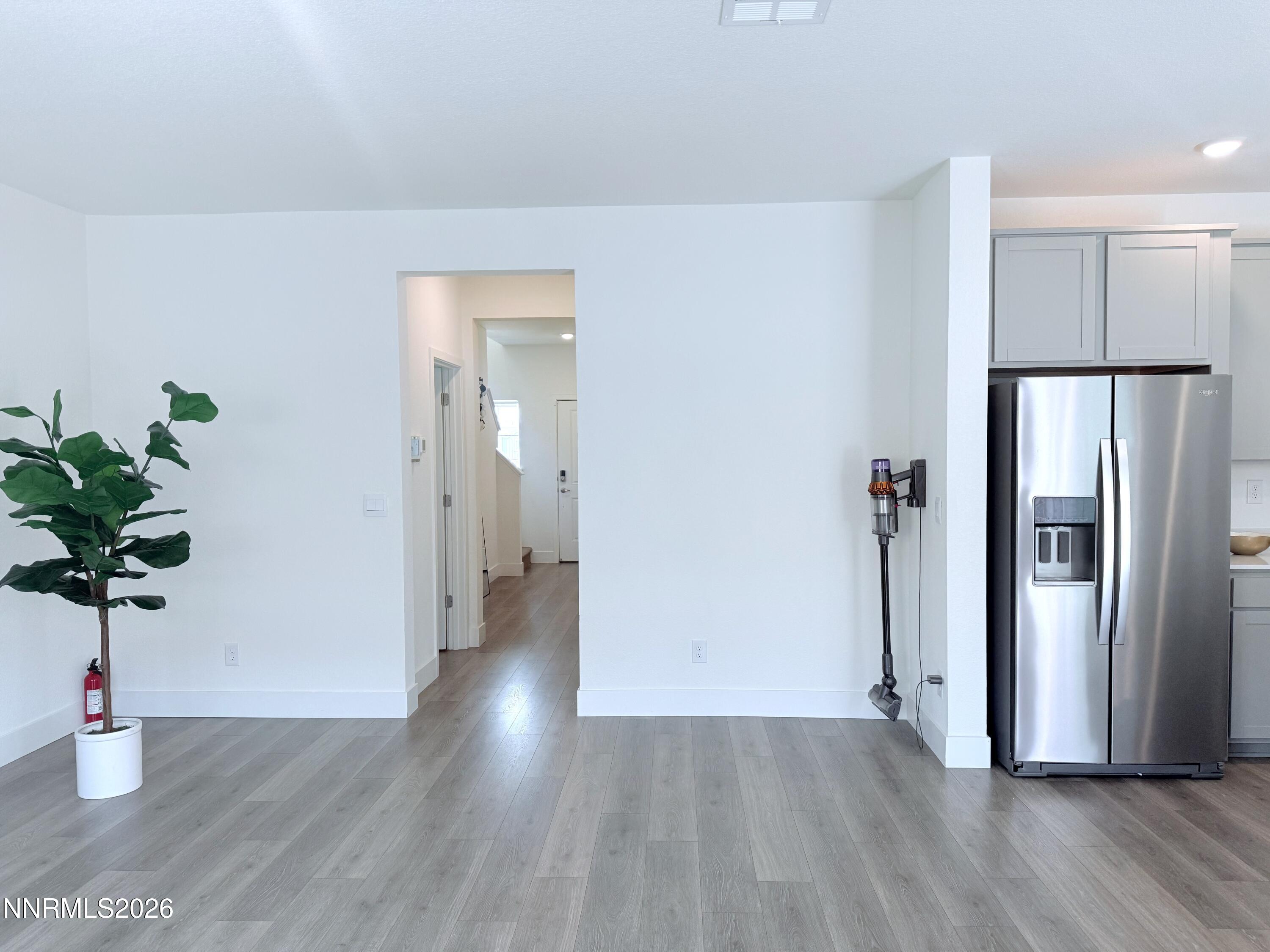 1433 Solitude Trail Reno, NV 89523 - Photo 10 of 35 a view of a hallway with wooden floor and a potted plant