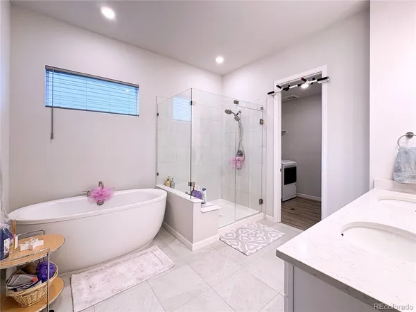 a spacious bathroom with a shower a sink and mirror