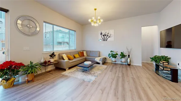 a living room with furniture and a chandelier