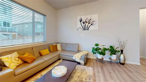 a living room with furniture and a large window